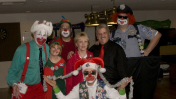 Our favorite Seafair Clowns; “Spotty”, “Uncle Sam”, “Leprechaun” & “Officer Lumpy” were in attendance to entertain the kids!  Suzie Allen was the “Christmas Elf”. Pictured with Loretta White & Trustee Nick Santora.