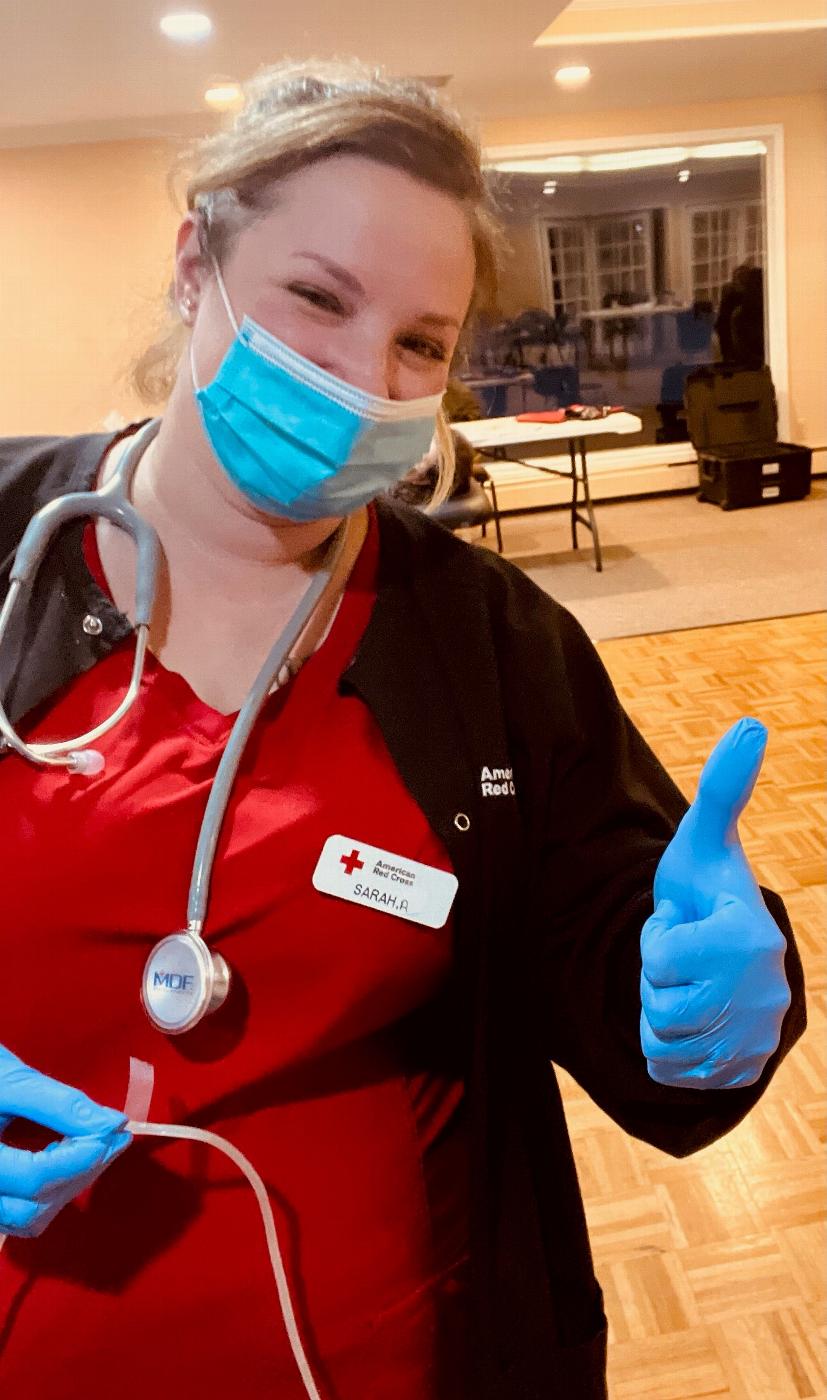 Red Cross volunteer Sarah A. getting ready to draw blood from Scott R. Harris, PER