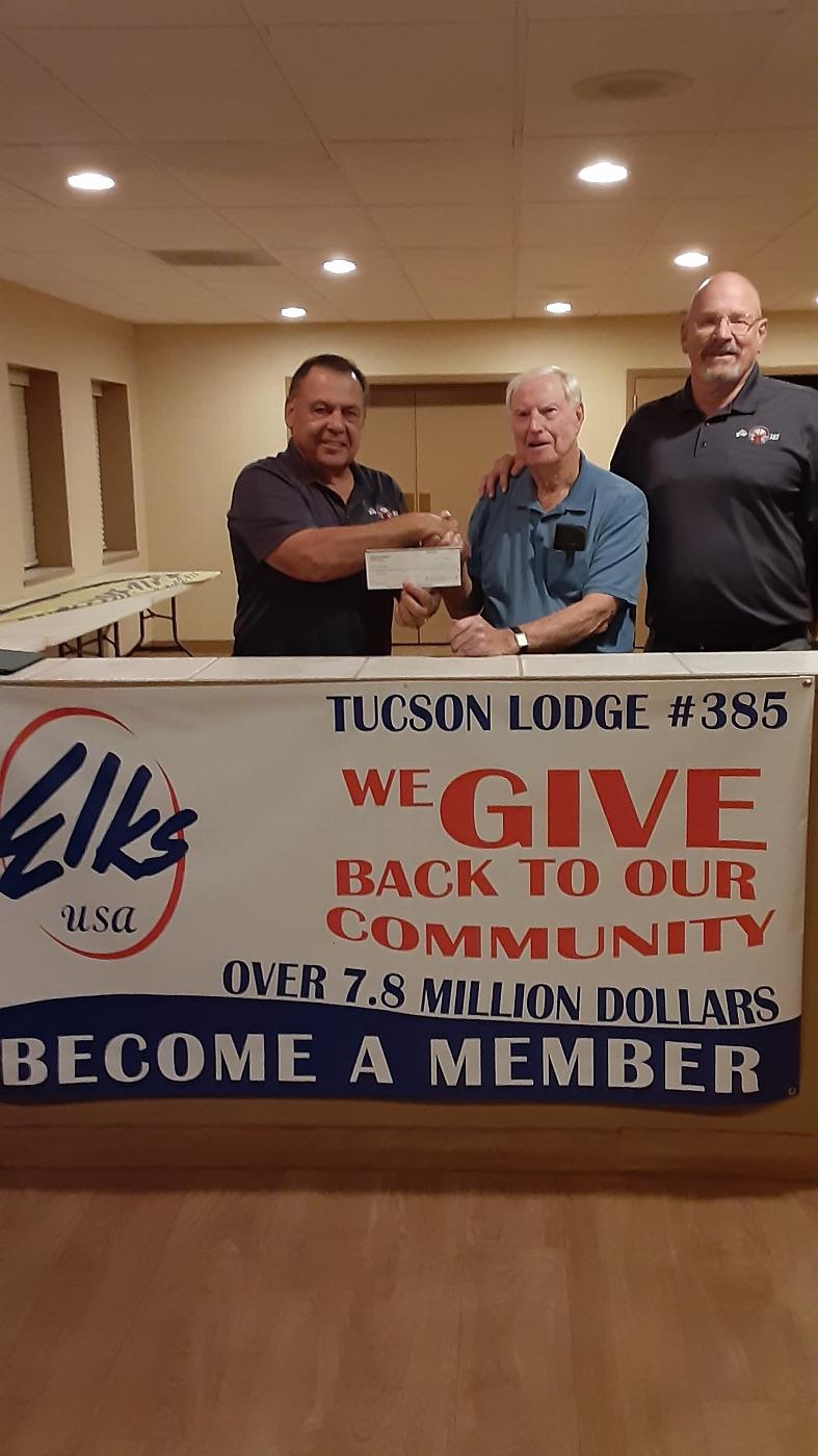 November 23, 2021, Tucson Elks Lodge donation of $2,750.00 to Lugo Charities for the annual "Bike in a Box" children's bike donations. L-R: Lecturing Knight M. Lessley, J. Lugo and House Committee Chairman Bob Holyoak. 
