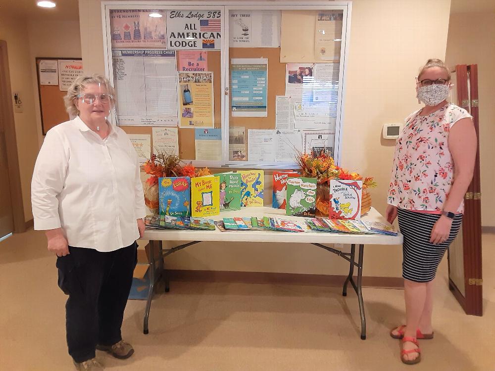 Tucson Elks Lodge #385 donating $665.00 in kids reading books.  Pictured L-R: Treasurer D. Gnuschke and Tucson Sunnyside Principal Sierra 2-8 School,T. Emerson. September 1, 2020