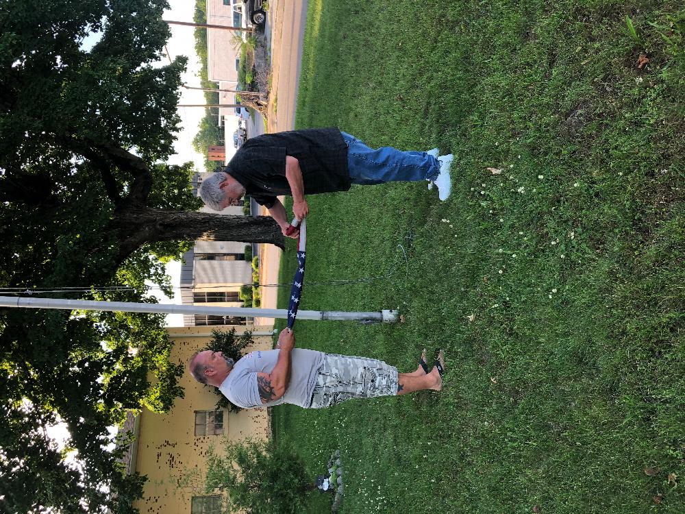 Trevor Herndon & Jeff Branson folding the old flag.