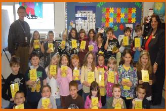                 DICTIONARY DRIVE
E.R. Laurie is shown presenting the dictionaries with Principle Mr. Brooks to Mrs. Card’s 3rd grade class at the H.B. Burkland School in Middleboro.