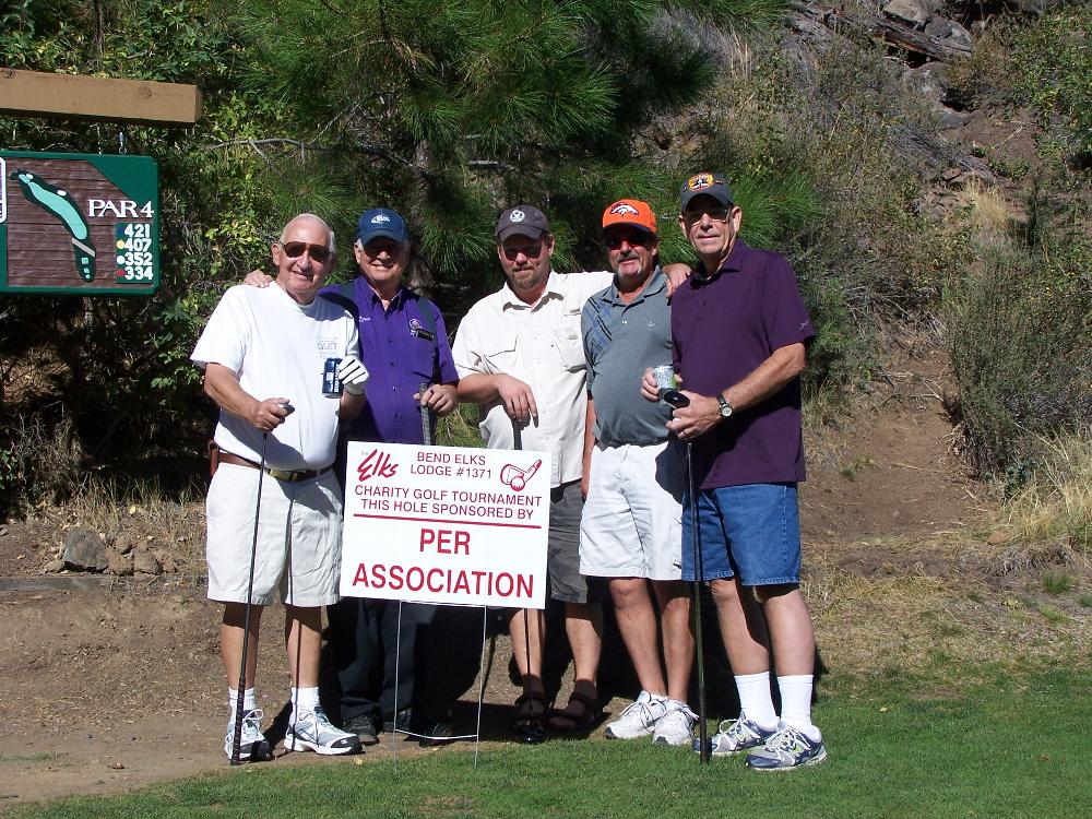 Four PERs posing with their sponsorship sign.  Left to right: Jerry Sherman PER, Don Gotcher PER, Greg Jolley providing support in the middle, Bob Little PER, Lee Thorsell PER.