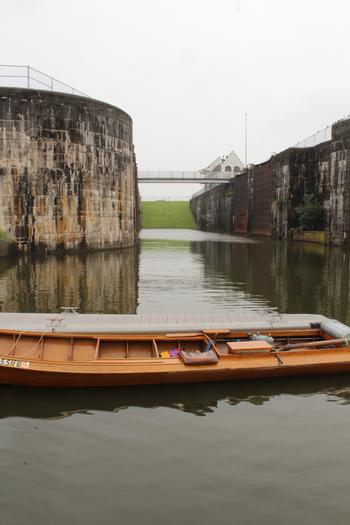 The historic Bayou Plaquemine Lock System. When operational it would let passage of Tug Boats from the Mississippi River into Bayou Plaquemine. It would then connect to the Intra-coastal and Atchafalaya water ways. The boat is an antique (Putt-Putt) water powered Atchafalaya basin runabout.