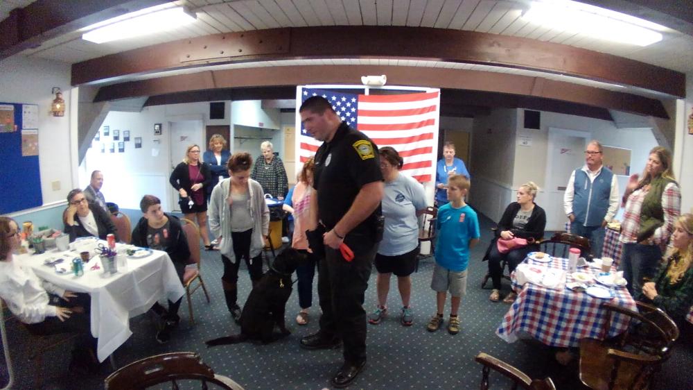 Barnstable Police K-9 Officer Kevin Fullam and his English Black Lab Yvonne demonstrates drug sniffing techniques. Yvonne is a working dog that gets fed when she discovers drugs. Synthetic drugs were used in the demonstration. 