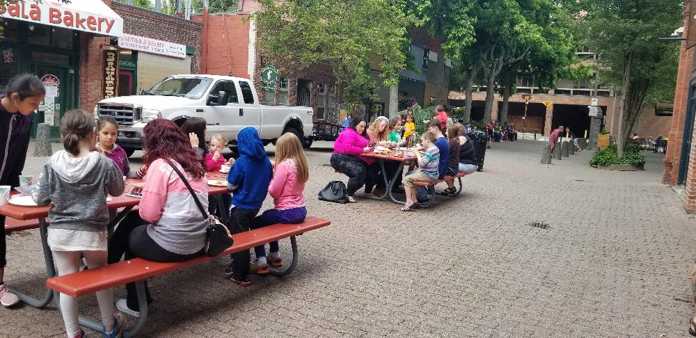 Families eat at Picnic Table in Pine Park after the movie.