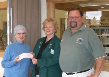 Friends of the Library Member Mary Peterson receives a check for $1,451 from ER Jeanne Uzelac and PER & Elk of the Year Tracy Gardner.  Proceeds from our Read the Greens Golf Tournament to support the Seaside Library.