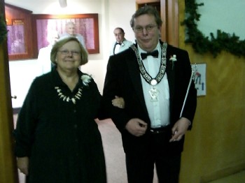 Outgoing Esquire Dennis Brodigan escorts Maureen,  wife of 5 Year Trustee James Casterline