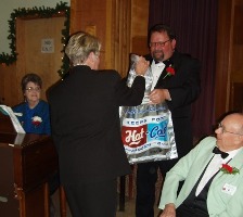 Mary Jones & Don Hoyer watch as Joan Beneke presents the outgoing ER Tracy with some good LARGE mushrooms.