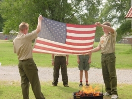 The Boy Scouts showing the proper way to retire the colors when they are tattered and worn. This is presenting the colors.