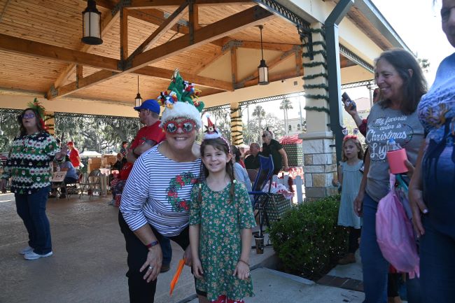 Mary Bolla greeting one of the children at Santa's Workshop