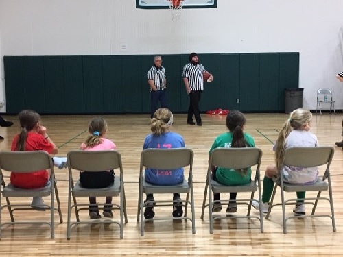 This group of 2019 Hoop Shoot participants is shown waiting for their turn to compete.