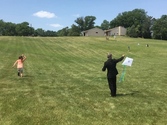 Former Lodge 1953 PER Marc Ulmen received the "best dressed volunteer" award at the 2020 Kite Day.  He is shown here helping one of the attendees in getting her kite to soar.