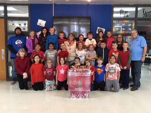 Pierre Elks Lodge 1953 ER Jonathon Ward (upper left) and Elks Veterans Christmas project chairman Jerry Wattier (upper right) pose with other lodge members and students from Jefferson Elementary School in November 2019.  The school was one of the locations where donations were accepted for the 2019 Elks Veteran's Christmas Project.