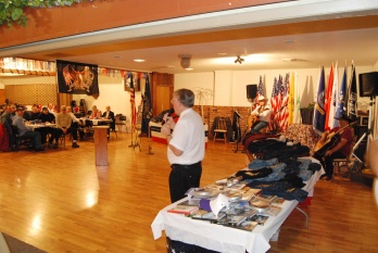 PDDGER J. Michael Lusk talking to the local Veteran's present for our annual Veteran's Potluck. He is telling them about the many coat, sweatshirts, CD's, books and other items being donated to the local VA Hospital for them.