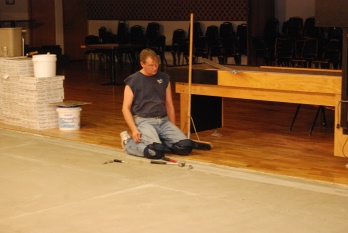 Member Tom Smith is preparing the dining room floor for the new tile.