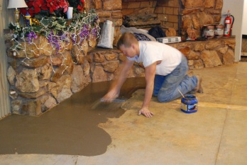 Member Tim Smith in action preparing the dining room floor for new tiles.