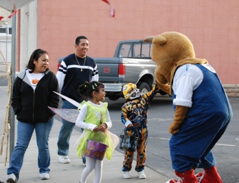 Casey Elk gives a trick-or-treater a high four during the Halloween safe kids Main Street celebration.