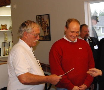 PER Larry Hetterley with State Representative Greg Smith at the Veteran's Flag pole ceremony. Lecturing Knight Mike Jones in the back.