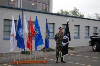 The troop homecoming was attended by an Honor Guard from the Lodge. Here Kevin Hetterely proudly represents with the Service Flags and the POW Flag.