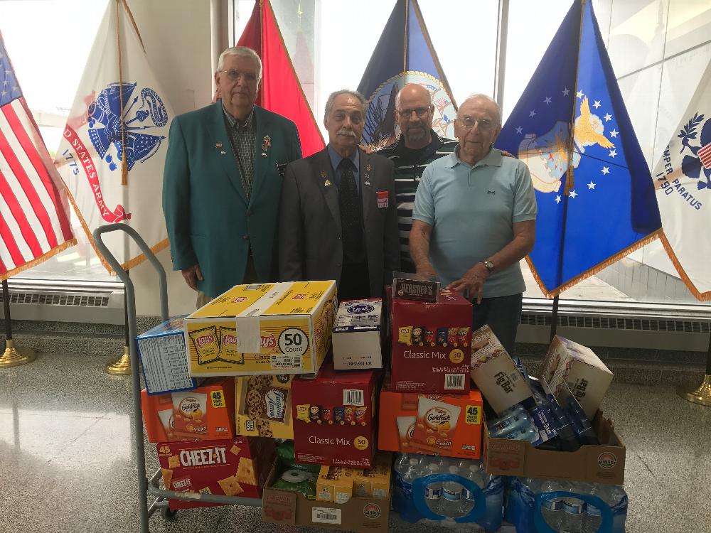 Treasurer Bob McIntyre, PDDGER Rocco Arcaro, and Veterans' Affairs Chairman Bob Maraio deliver supplies to the Harrison Courtsey Room at the Syracuse International Airport. Supplies are intended to comfort active duty military personnel as they travel through the airport. (2019)