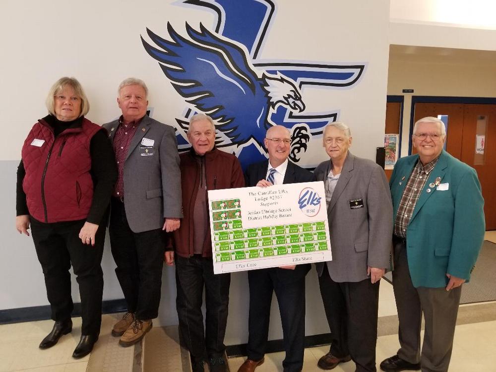 Secretary Cheryl Chesneski, ER Jim Roe, Trustee Stan Chesneski, PER Lee Ireland, and Treasurer Bob McIntyre present 30 - $25.00 Walmart gift certificates to the Jordan Elbridge School District for their Holiday Bazaar. This gift was made available through a Gratitude Grant for ENF. (November 2018)