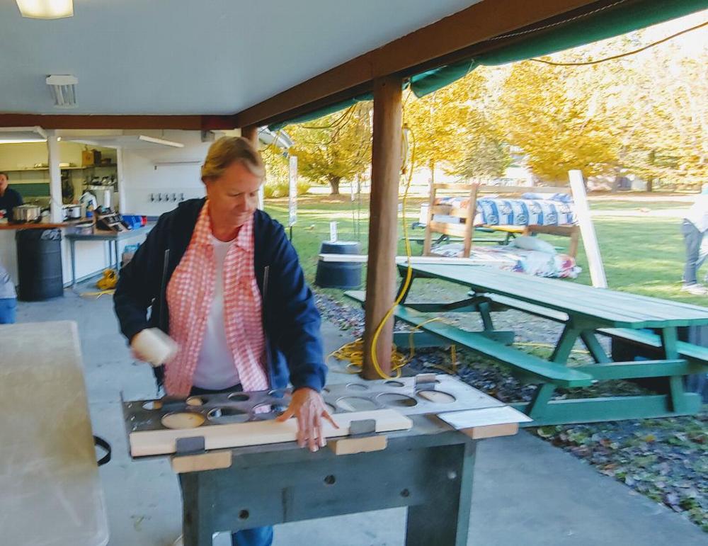 Volunteer member Merry Varkett swings a hammer  as she participates in building bunk beds. Beds are built for children who may otherwise sleep on the floor. (10/13/19)