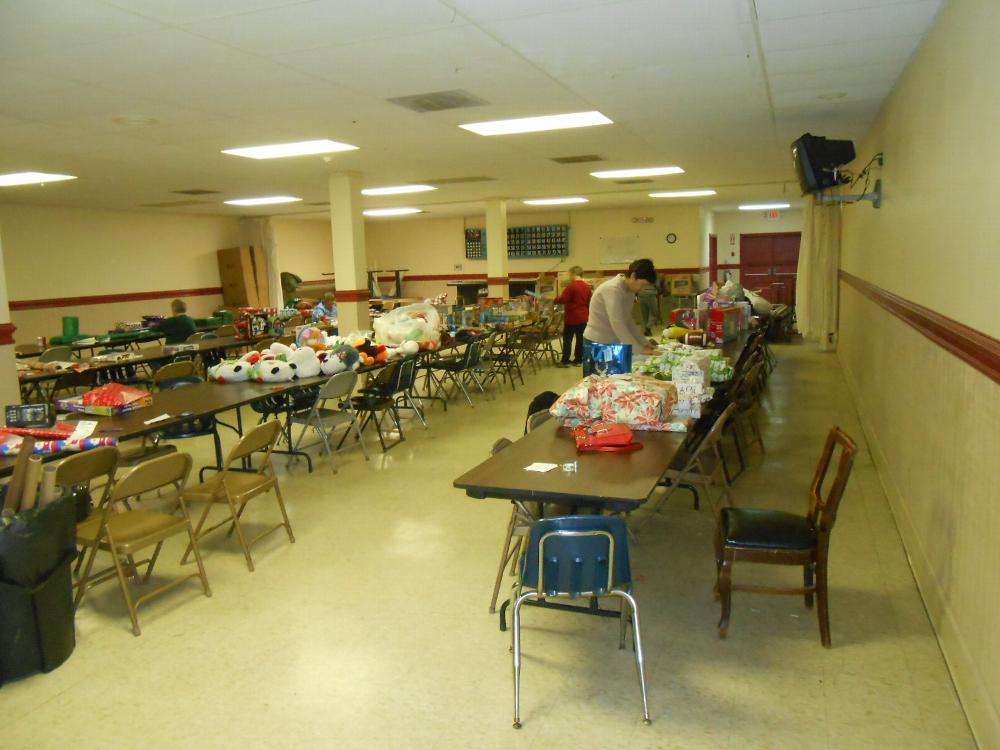 Gifts being selected and wrapped.  The gifts are for the children of the families assisted with the food baskets.