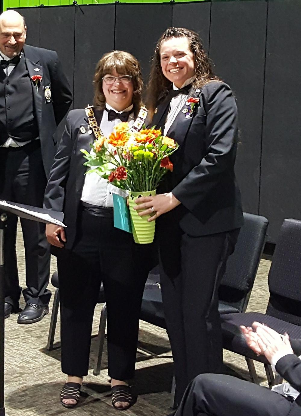 New Exalted Ruler Diana presenting flowers to exiting Exalted Ruler Allison