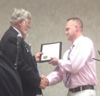 Montague Police Chief Charles "Chip" Dodge receives the Citizen of the Year award from 2013-2014 Exalted Ruler Stephen Dacyczyn April 5, 2014