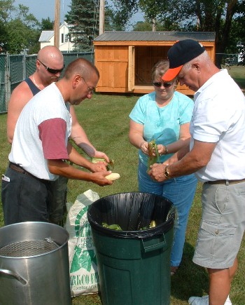 Darrell "Erkel" Gallant, Travis Poulin, Cheryl LeClair and Gary LeClair volunteered for "cornhusking" duties at the field day.