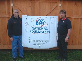 Bryan (left) and Randy Lancaster display the race car hood that was driven at the July 28, 2007 Mini-Stock feature at Wiscasset Raceway. Proceeds from the signatures on the hood will go toward the Elks National Foundation.