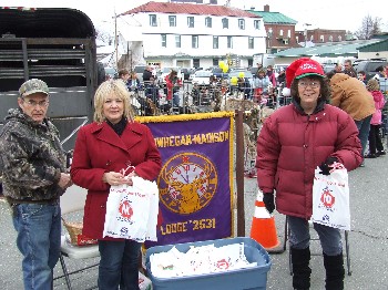 Richard Corson, PER Julie Washburn and Bobbi Alley from the Skowhegan-Madison Elks passed out more than 200 coloring books, crayons, rulers and candy canes at the children's petting zoo during the Dec. 4 Skowhegan Downtown Stroll. The petting zoo was sponsored through a Promise Grant from the Elks National Foundation and the promotional material was provided by the Elks Drug Awareness program.