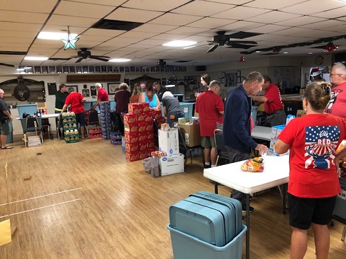 Our Lodge volunteers working to put together food packages for in need community members.