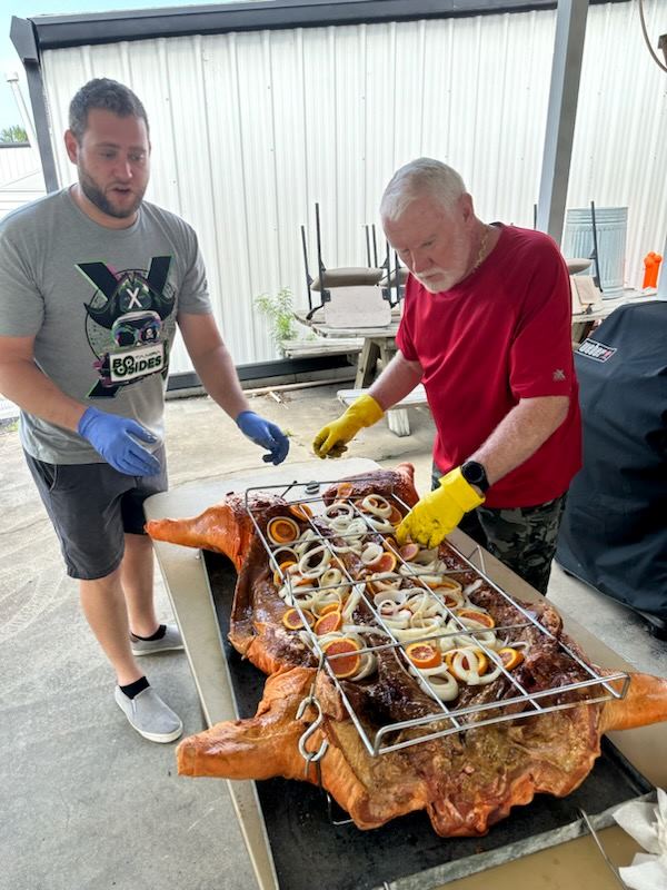 Tom's son pitching in to help lift and cook dinner.