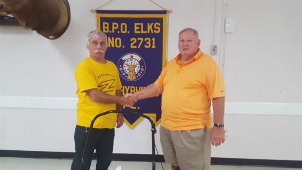 Ken Fabiani, Exalted Ruler of Elks Lodge #2731 presents a Leaf Blower to Darryl Oney, VP of the Zephyrhills Little League.
