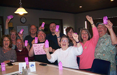 picture of elks gathered around bar cheering